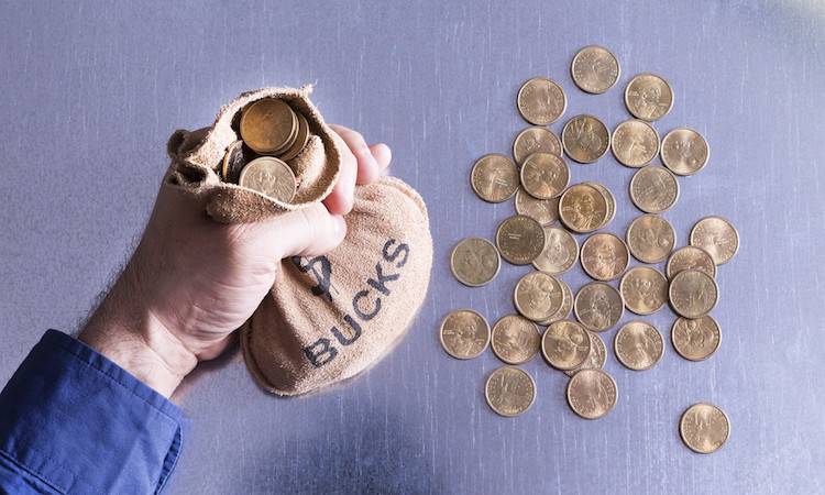 Man holding a money bag full of Bucks