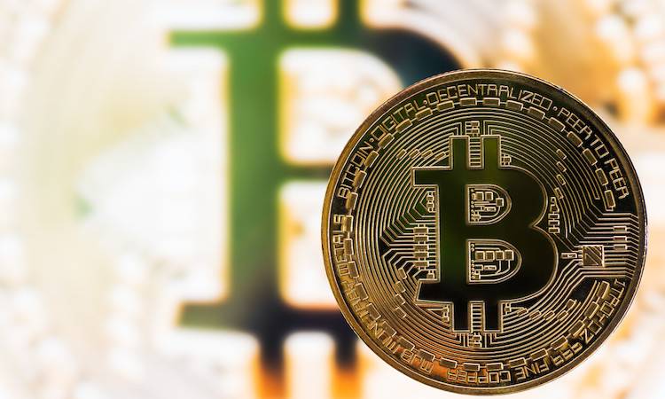 Golden color bitcoin on a blurred bitcoin background